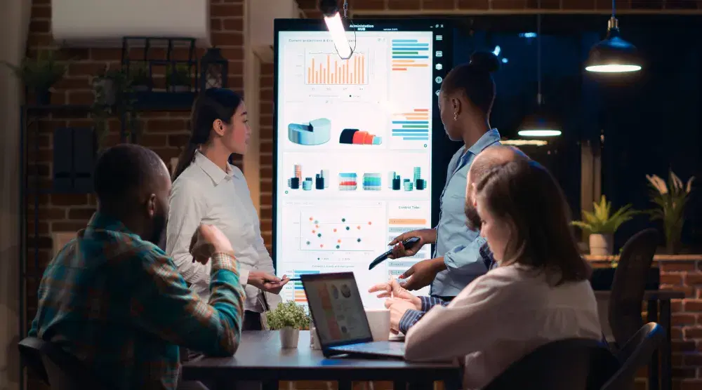 A group of people gathered around a table at a business meeting