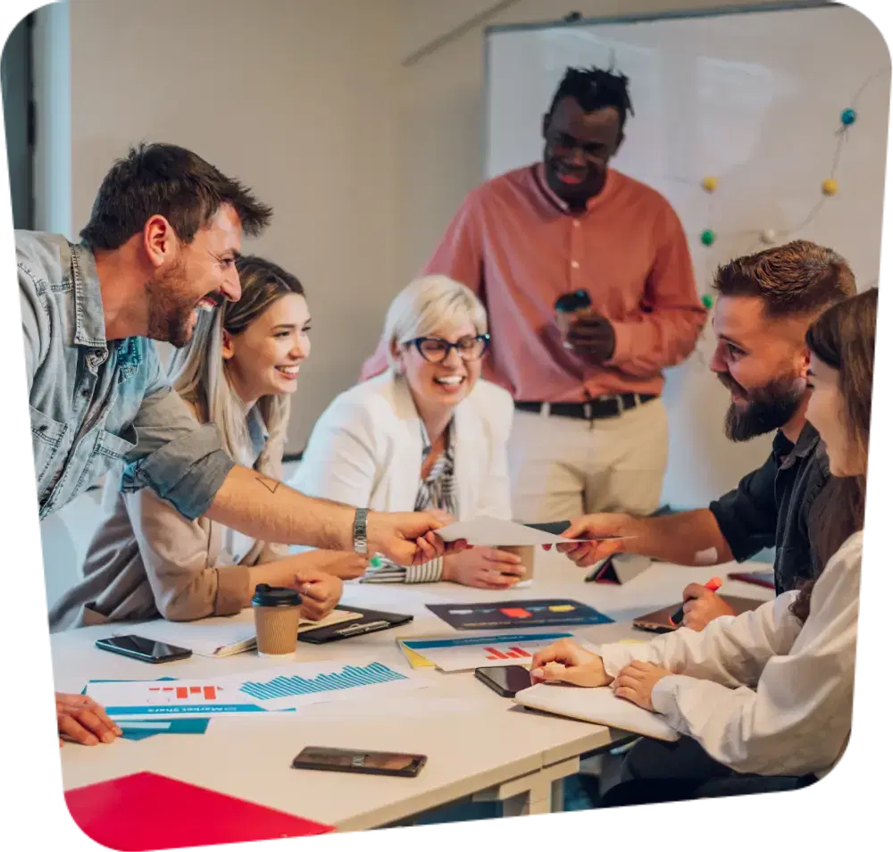 A group of people gathered around a table at a business meeting