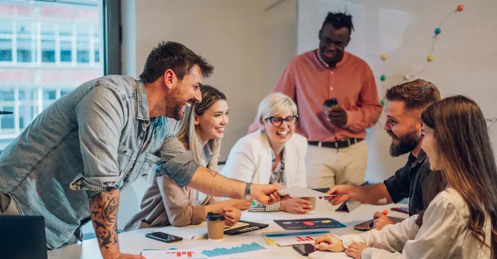 A group of people gathered around a table at a business meeting